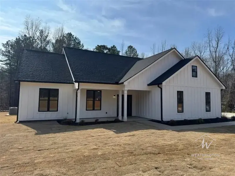 Modern farmhouse new construction with black trim by Weathington Fine Homes in Griffin Georgia