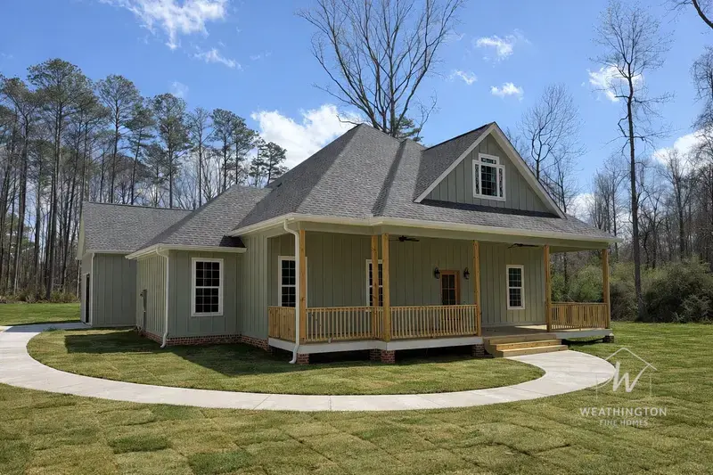 Craftsman style new construction home with wraparound porch and board-and-batten siding built by Weathington Fine Homes in Williamson Georgia